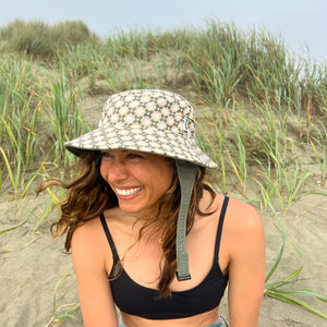 green and tan patterned surf hat