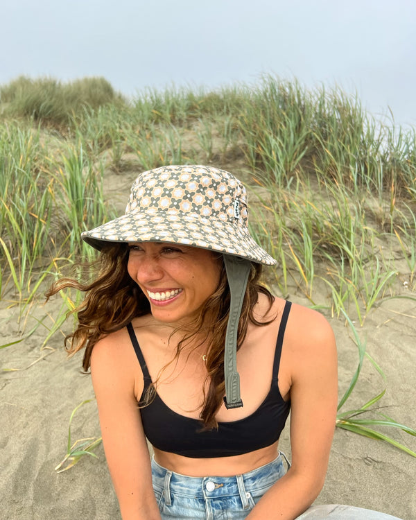 green and tan patterned surf hat